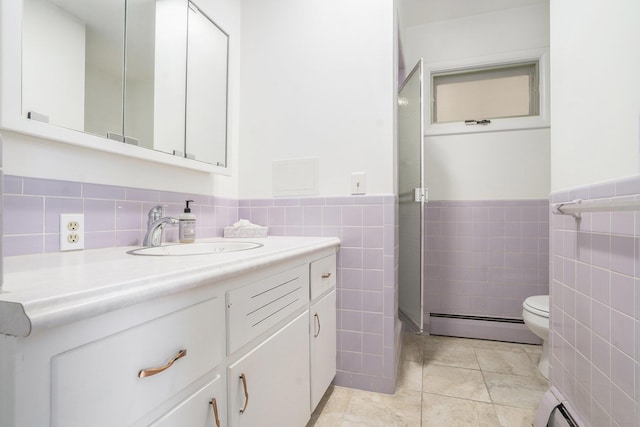 bathroom featuring tile walls, tile patterned floors, vanity, and a baseboard heating unit