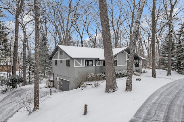 view of snow covered exterior with a garage