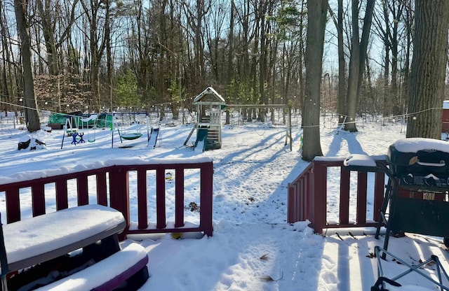 snow covered deck with a playground