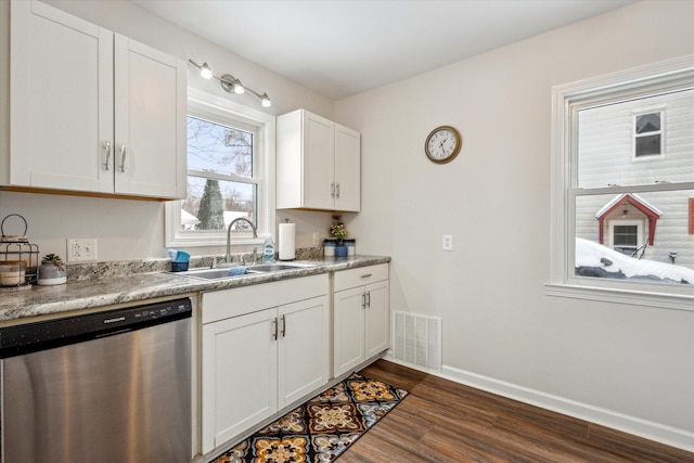 kitchen featuring stainless steel dishwasher, white cabinetry, sink, and dark wood-type flooring