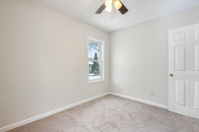 carpeted empty room featuring ceiling fan