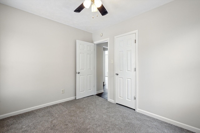 unfurnished bedroom with ceiling fan and carpet