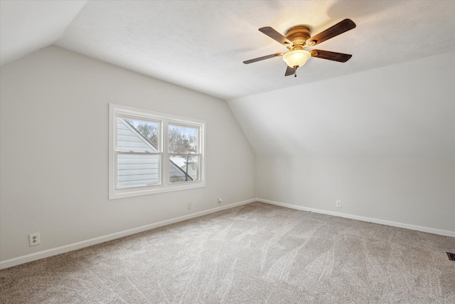 additional living space featuring ceiling fan, vaulted ceiling, and carpet