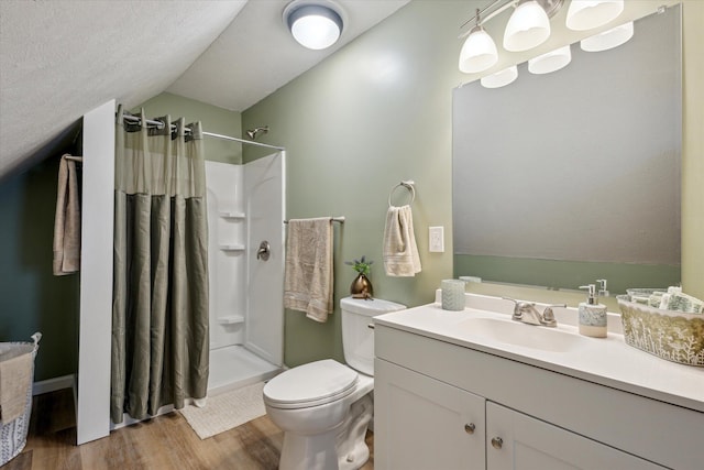 bathroom with lofted ceiling, a shower with curtain, wood-type flooring, and vanity