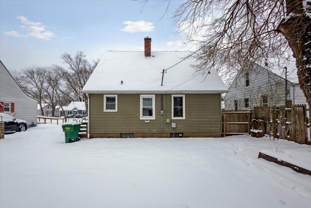 view of snow covered rear of property