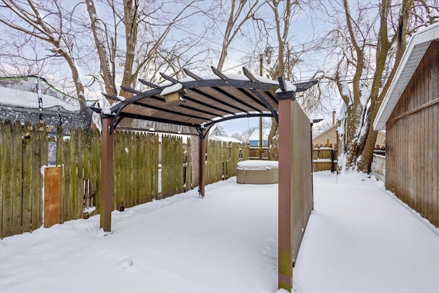 yard layered in snow with a pergola