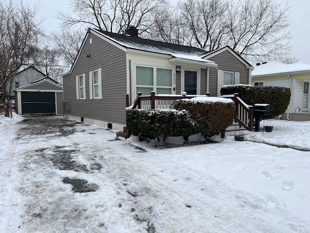 view of front of property with a garage and an outbuilding