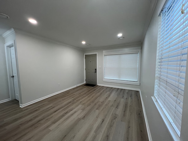 unfurnished room with crown molding and hardwood / wood-style floors