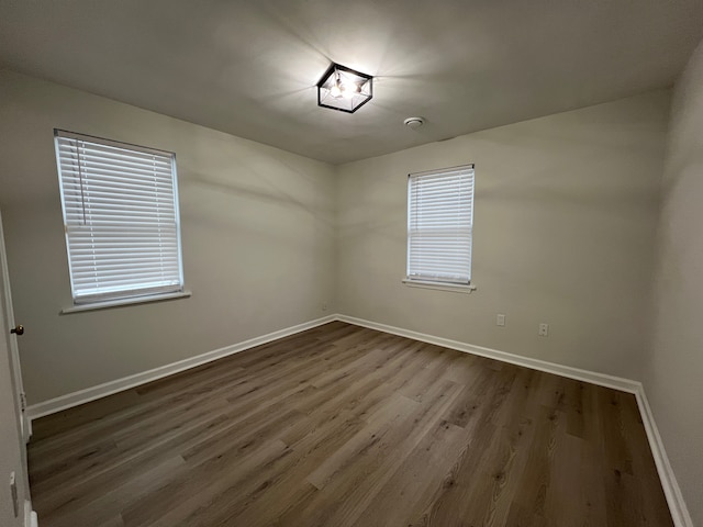 unfurnished room with wood-type flooring