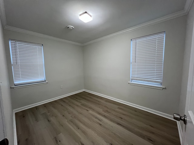 unfurnished room featuring ornamental molding and hardwood / wood-style floors