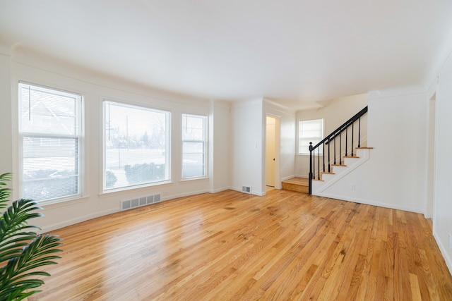 unfurnished living room with light wood-type flooring