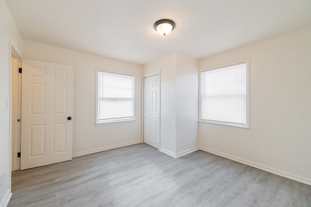 unfurnished bedroom featuring a closet and light hardwood / wood-style floors