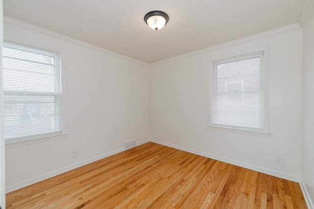 unfurnished room featuring ornamental molding and light hardwood / wood-style floors