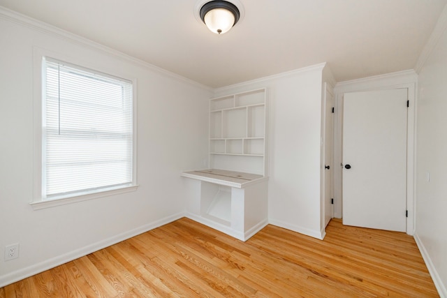 interior space featuring plenty of natural light, ornamental molding, and hardwood / wood-style floors