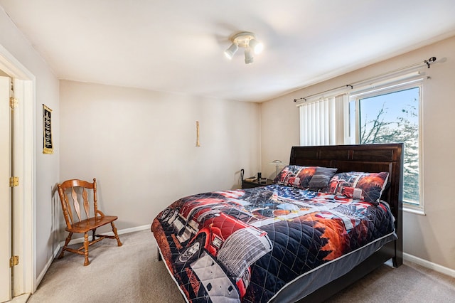 bedroom with light carpet and multiple windows