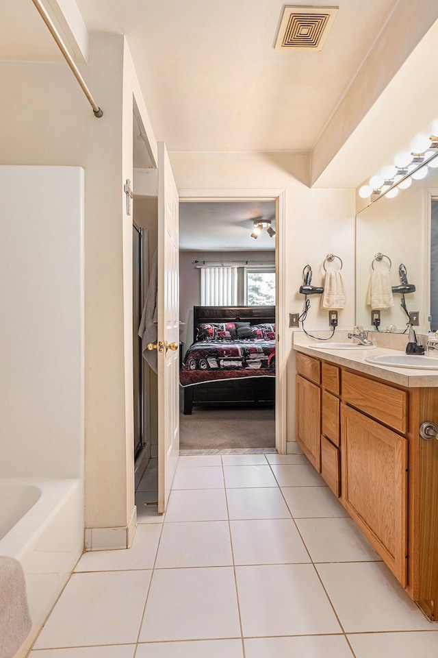 bathroom featuring tile patterned flooring, separate shower and tub, and vanity