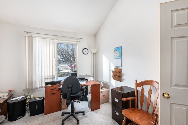 office space with vaulted ceiling and light carpet