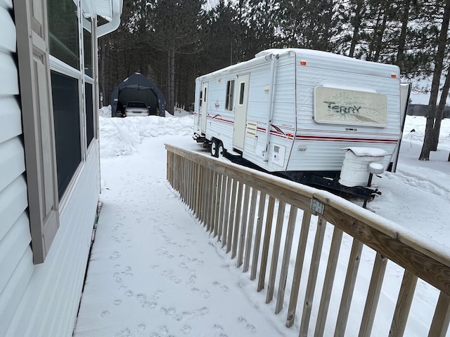 snowy yard with a garage