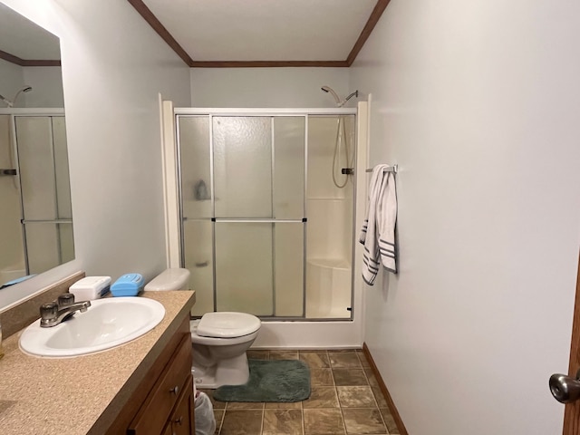 full bathroom featuring toilet, vanity, baseboards, a stall shower, and crown molding