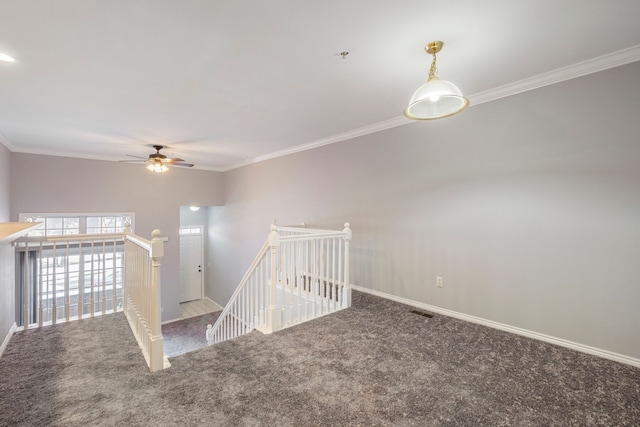 carpeted empty room with ornamental molding and ceiling fan