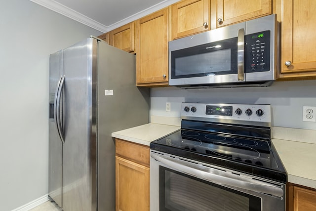 kitchen with appliances with stainless steel finishes and ornamental molding