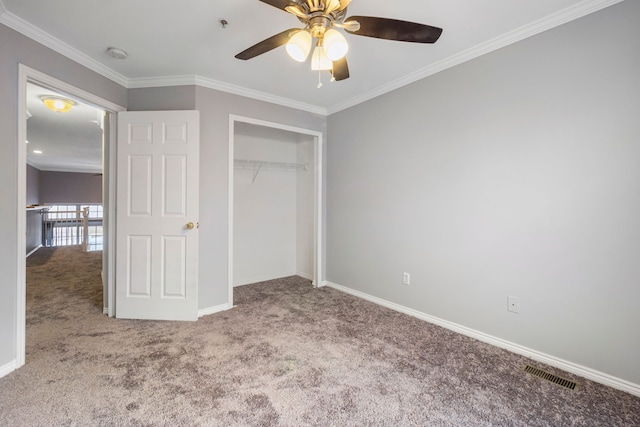 unfurnished bedroom with light colored carpet, ceiling fan, crown molding, and a closet