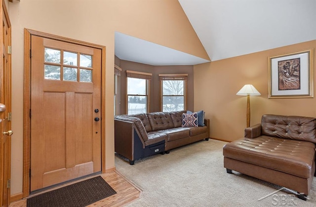 living room featuring lofted ceiling and carpet floors