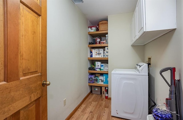 washroom with washer / dryer, light wood-type flooring, and cabinets