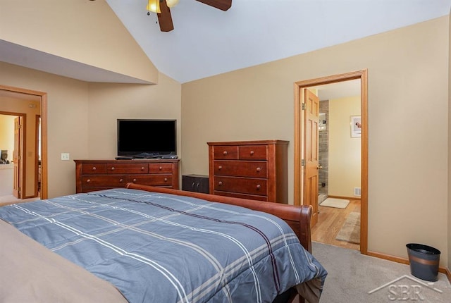 carpeted bedroom with ceiling fan, ensuite bathroom, and vaulted ceiling