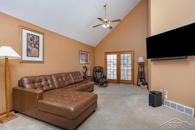 living room featuring high vaulted ceiling, light carpet, and ceiling fan