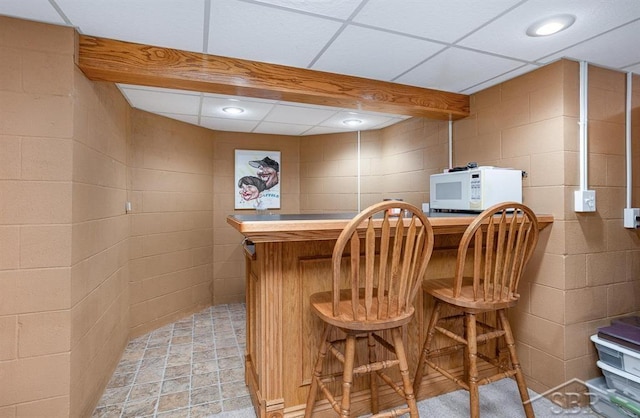 bar featuring a paneled ceiling