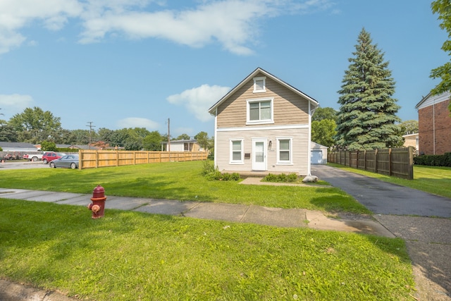 view of front facade featuring a garage and a front lawn