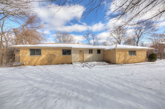 view of snow covered rear of property