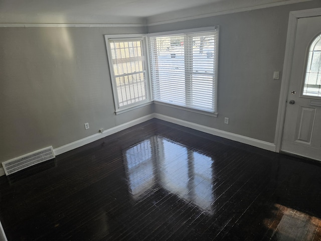 foyer featuring crown molding and dark hardwood / wood-style floors