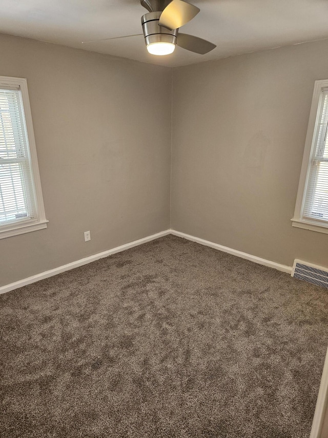 empty room featuring dark carpet