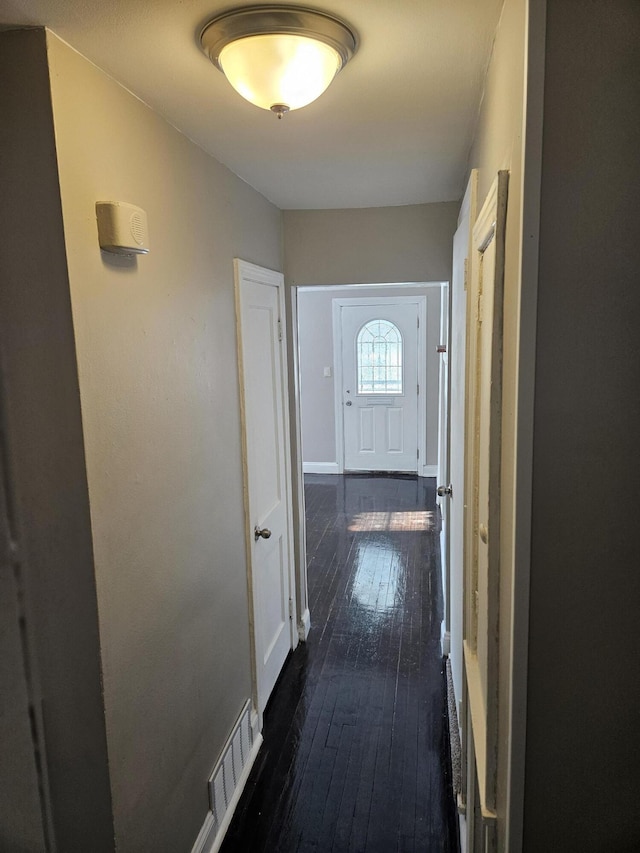 hallway with dark hardwood / wood-style flooring