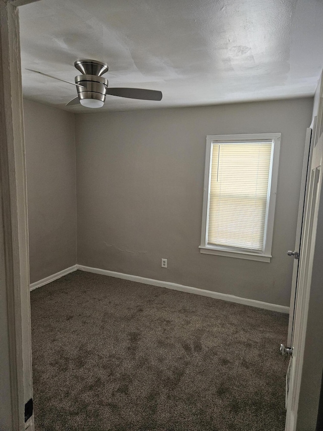 empty room featuring dark carpet