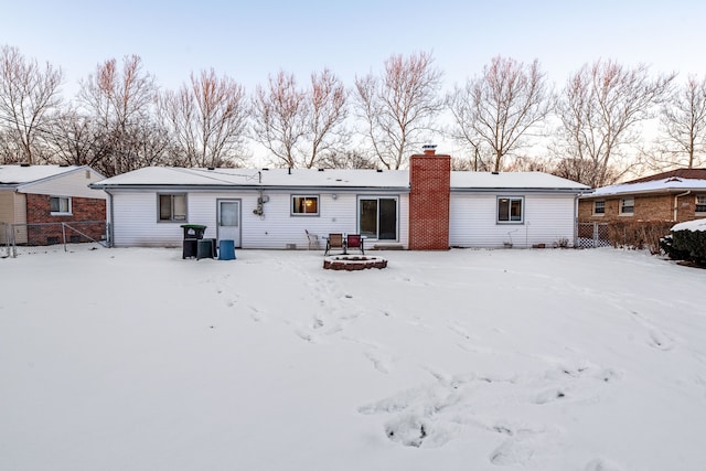 view of snow covered rear of property