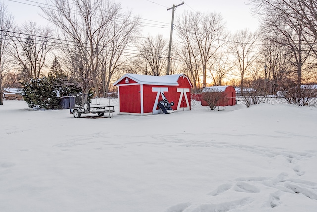 yard layered in snow with a shed