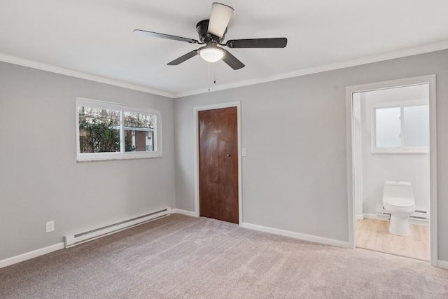 unfurnished bedroom featuring connected bathroom, baseboard heating, light colored carpet, ornamental molding, and ceiling fan