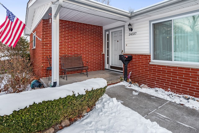 view of snow covered property entrance