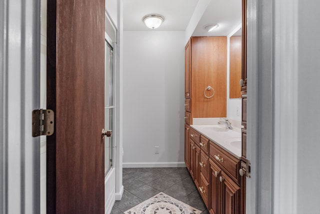 bathroom with combined bath / shower with glass door, tile patterned flooring, and vanity