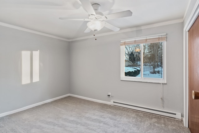 carpeted spare room featuring a baseboard heating unit, ceiling fan, and crown molding