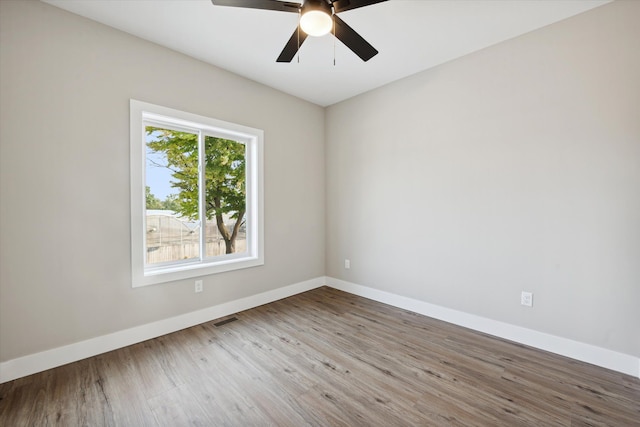 spare room with ceiling fan and wood-type flooring