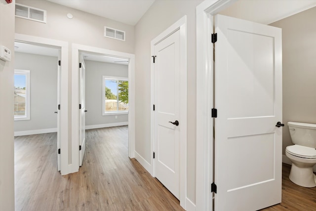 corridor with light wood-type flooring