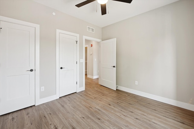 unfurnished bedroom with ceiling fan and light wood-type flooring