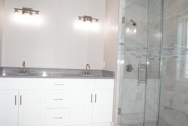 bathroom featuring walk in shower and vanity