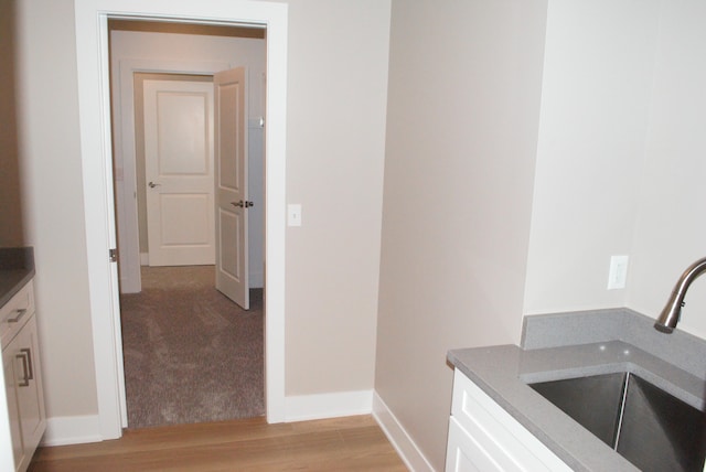 interior space featuring light wood-type flooring and sink