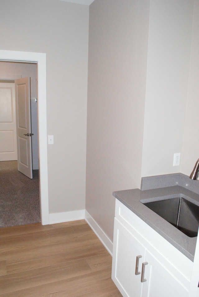 interior space with sink and light wood-type flooring