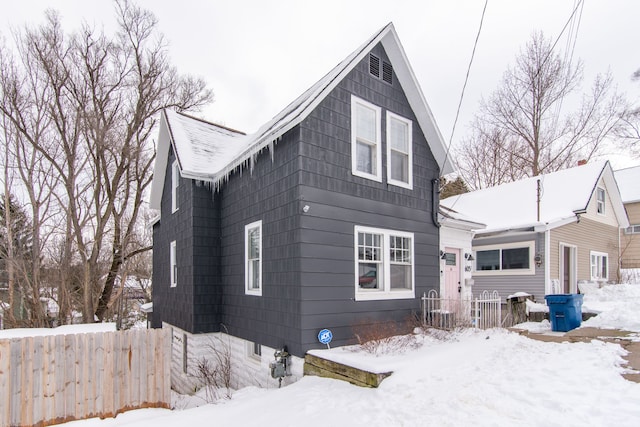 view of snow covered rear of property